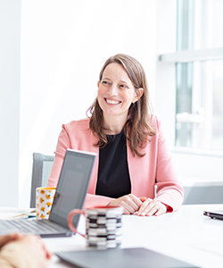 Bethany Miller sitting in a well lit office and smiling